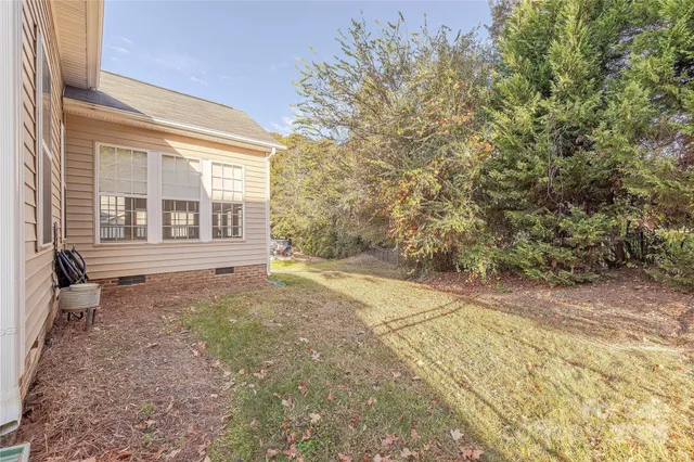 a view of a backyard with large trees