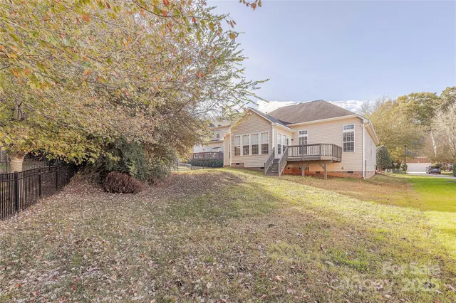 a view of a house with a yard and sitting area