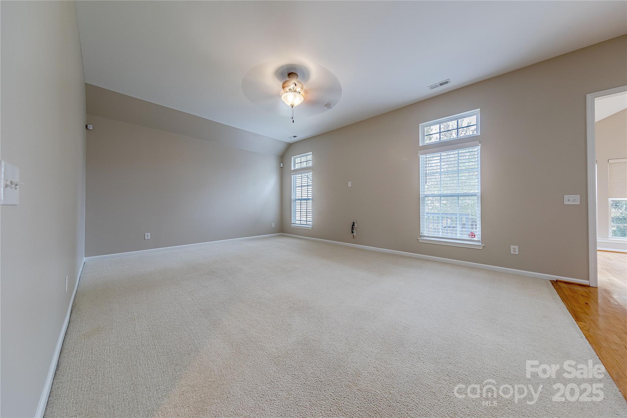 7216 Meyer Road Fort Mill, SC 29715 - Photo 7 of 47 an empty room with windows and chandelier fan
