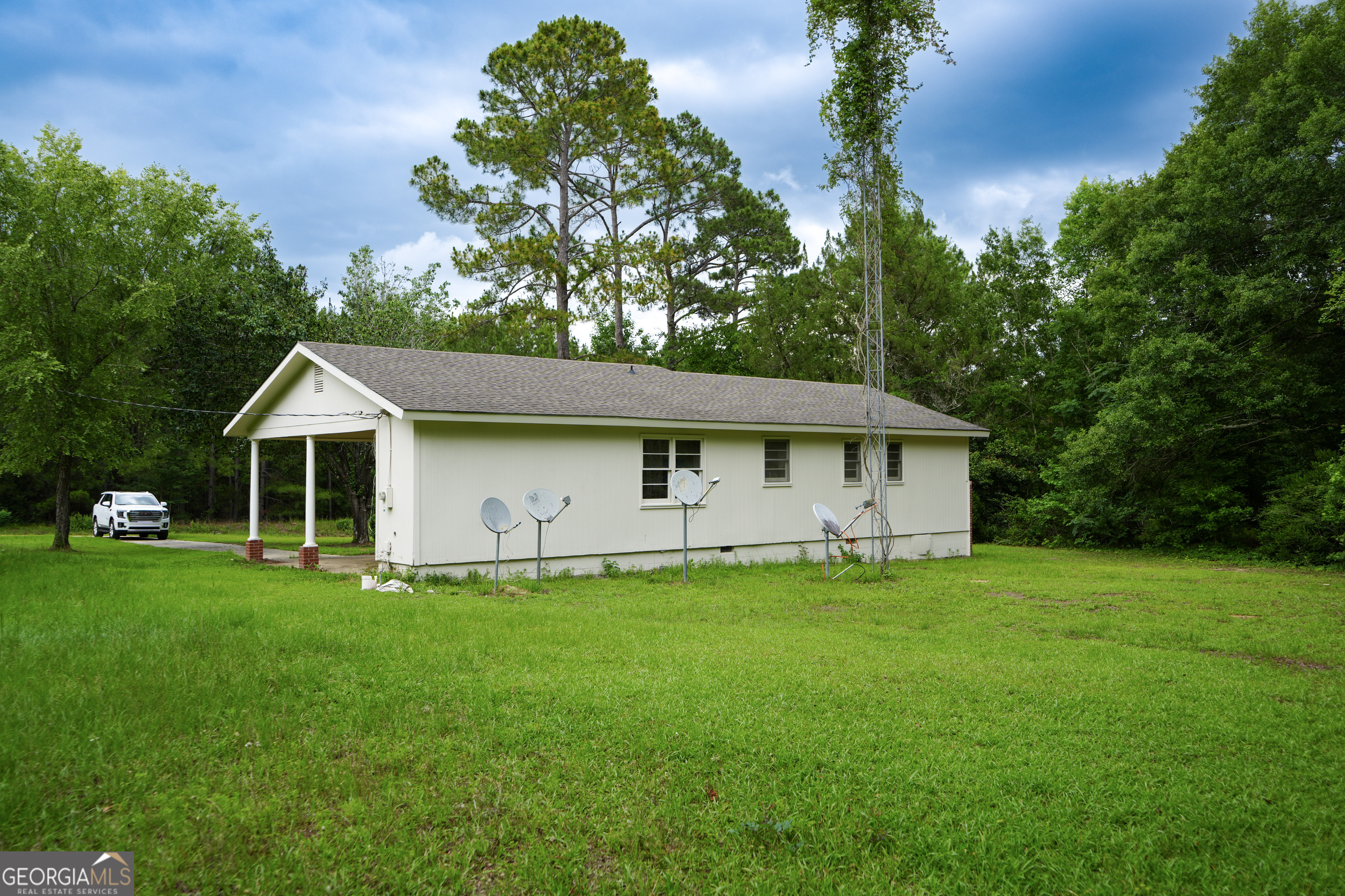 1869 Minter Blue Springs Road Rockledge, GA 30454 - Photo 13 of 45 a white house that has a tree in front of it