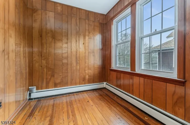 a view of a room with wooden floor and windows