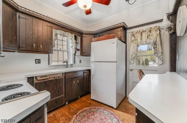 a kitchen with refrigerator cabinets and wooden floor
