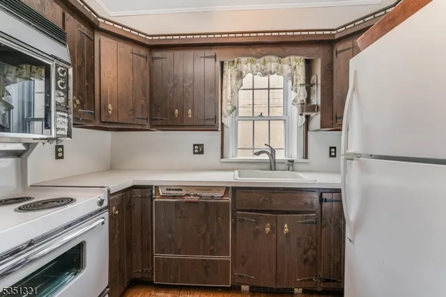 a kitchen with a sink stove and cabinets