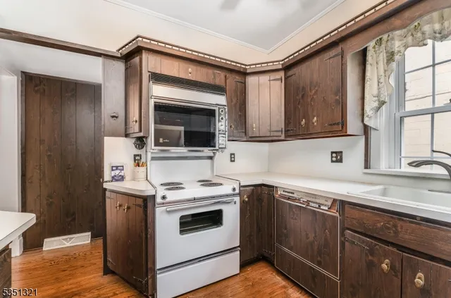 a kitchen with a sink stove and microwave