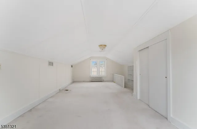 a view of a big room with closet and windows