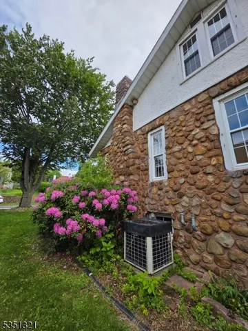 a house view with a sitting space garden view