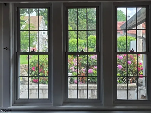a view of a house with a garden and sitting area