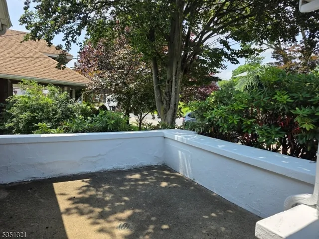 a view of a balcony with chair and wooden floor