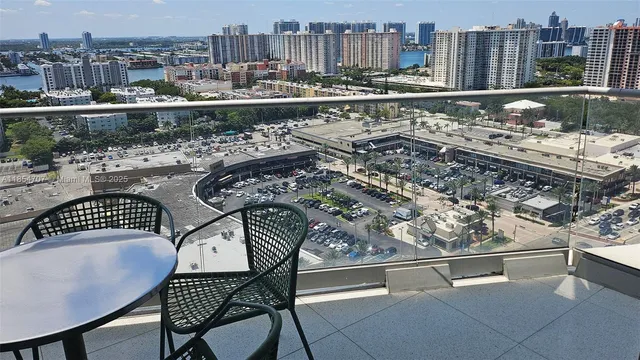 a city view from a balcony with wooden benches