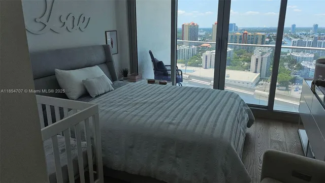 a bedroom with a bed and glass window
