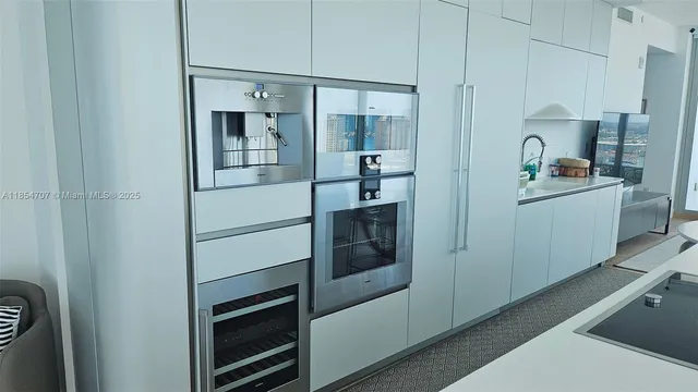 a kitchen with cabinets and stainless steel appliances