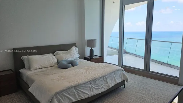 a bedroom with a large bed and a large window