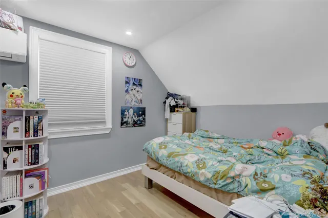 a bedroom with bed and a book shelf