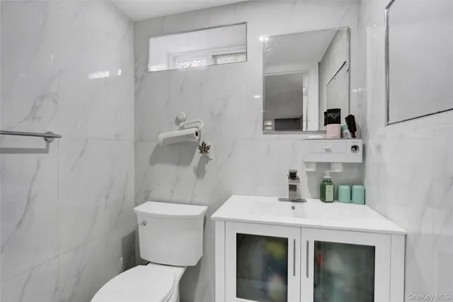 a bathroom with a sink a toilet and mirror