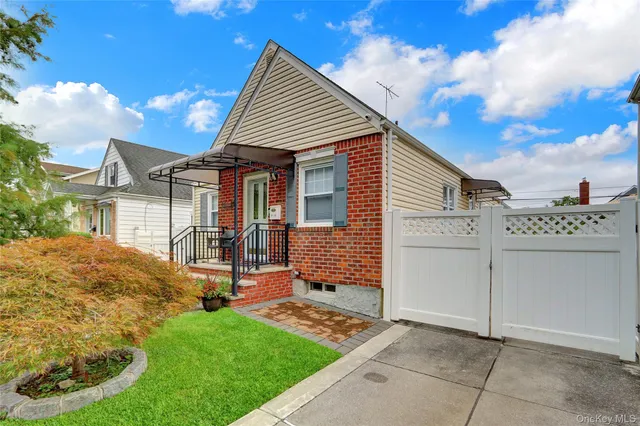 a view of a house with yard and a garden