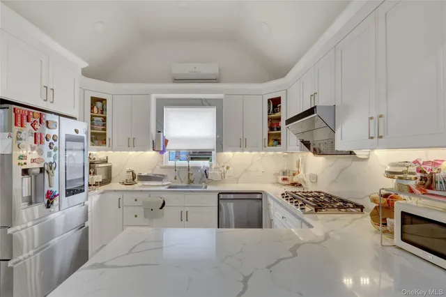 a kitchen with stainless steel appliances kitchen island granite countertop a sink and cabinets