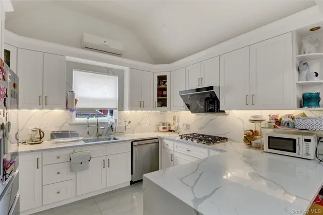 a kitchen with a sink stove and cabinets