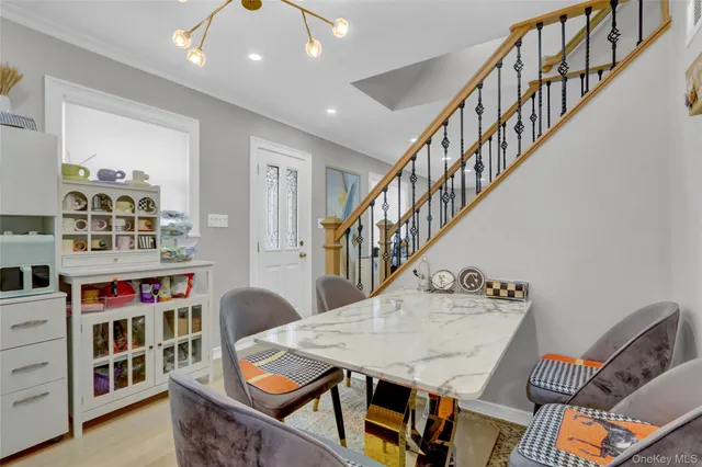 a dining room with furniture and a book shelf