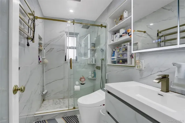 a bathroom with a sink toilet and shower