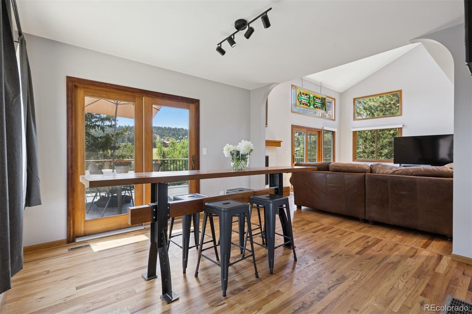 23860 Genesee Village Road Golden, CO 80401 - Photo 12 of 36 a view of a dining room with furniture window and wooden floor