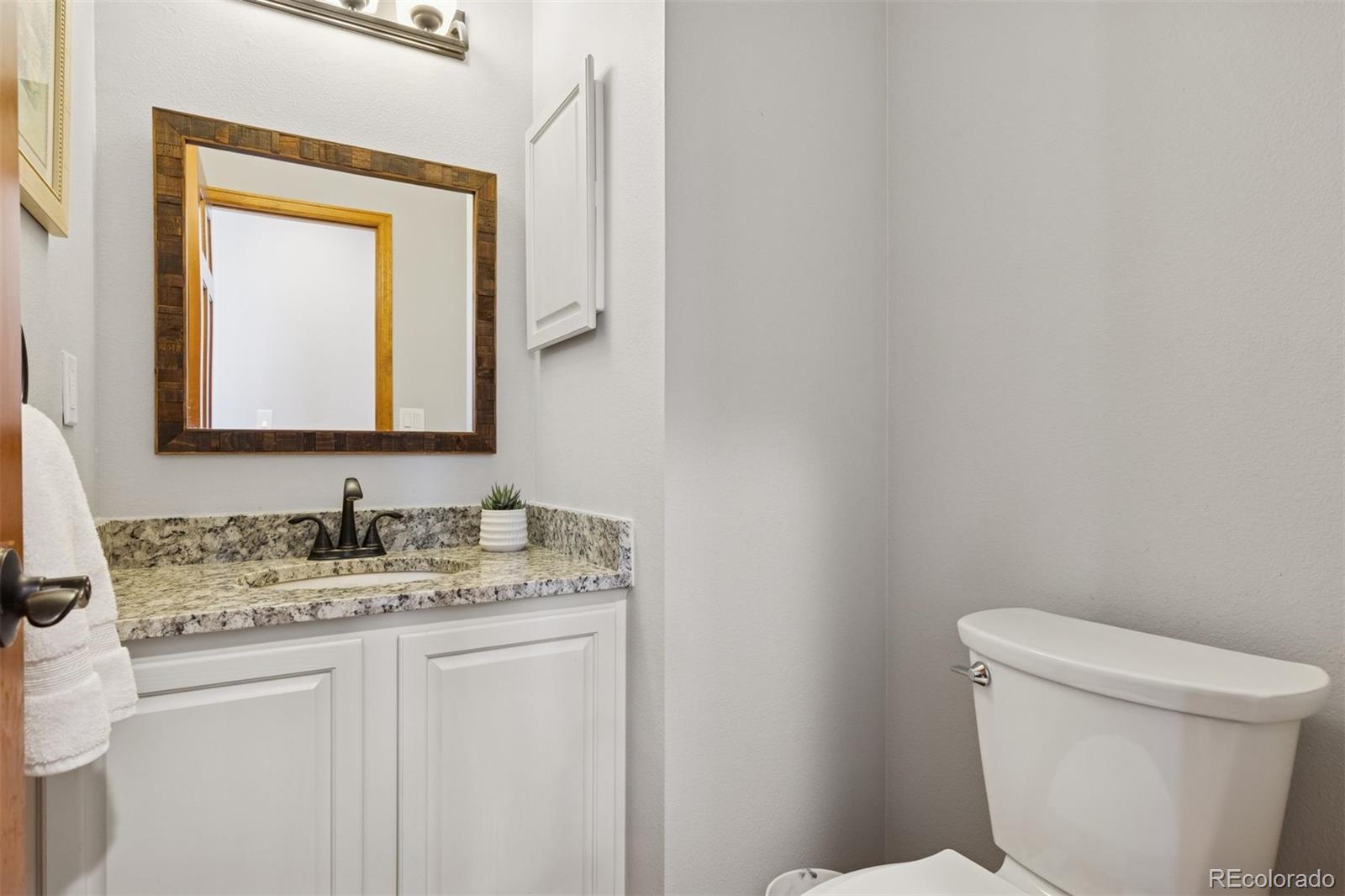 23860 Genesee Village Road Golden, CO 80401 - Photo 15 of 36 a bathroom with a toilet sink and mirror