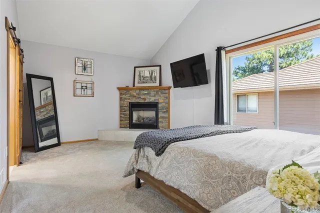 a bedroom with a bed and a fireplace