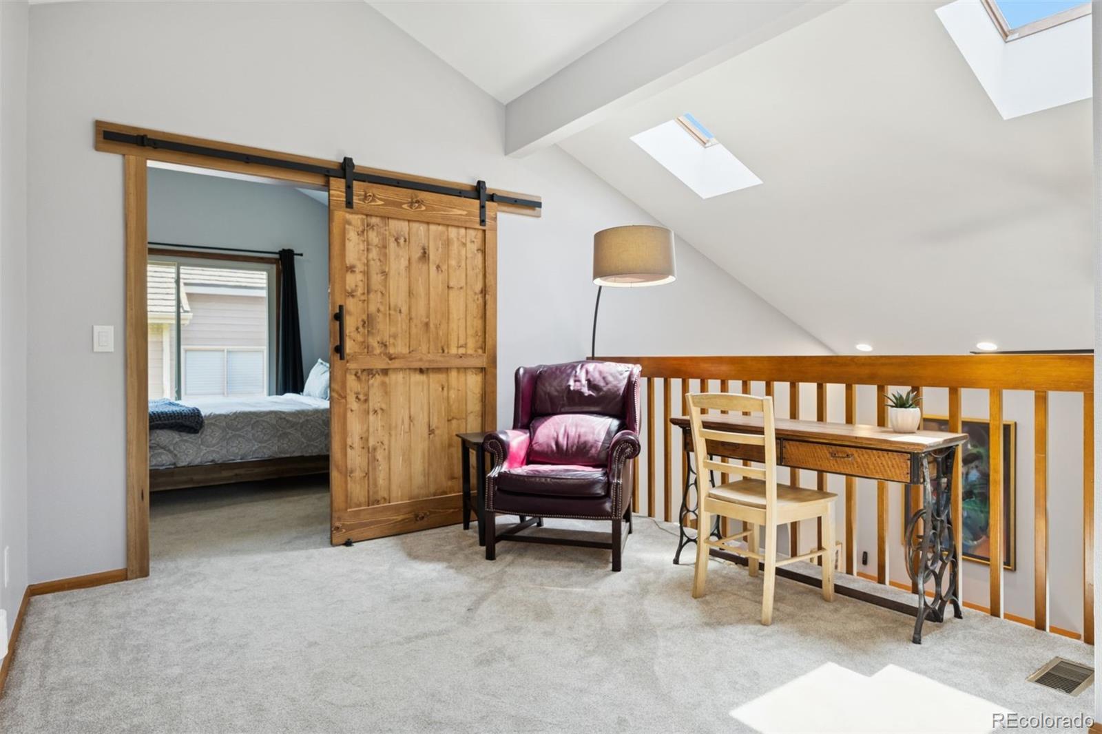 23860 Genesee Village Road Golden, CO 80401 - Photo 21 of 36 a bedroom with furniture and a window