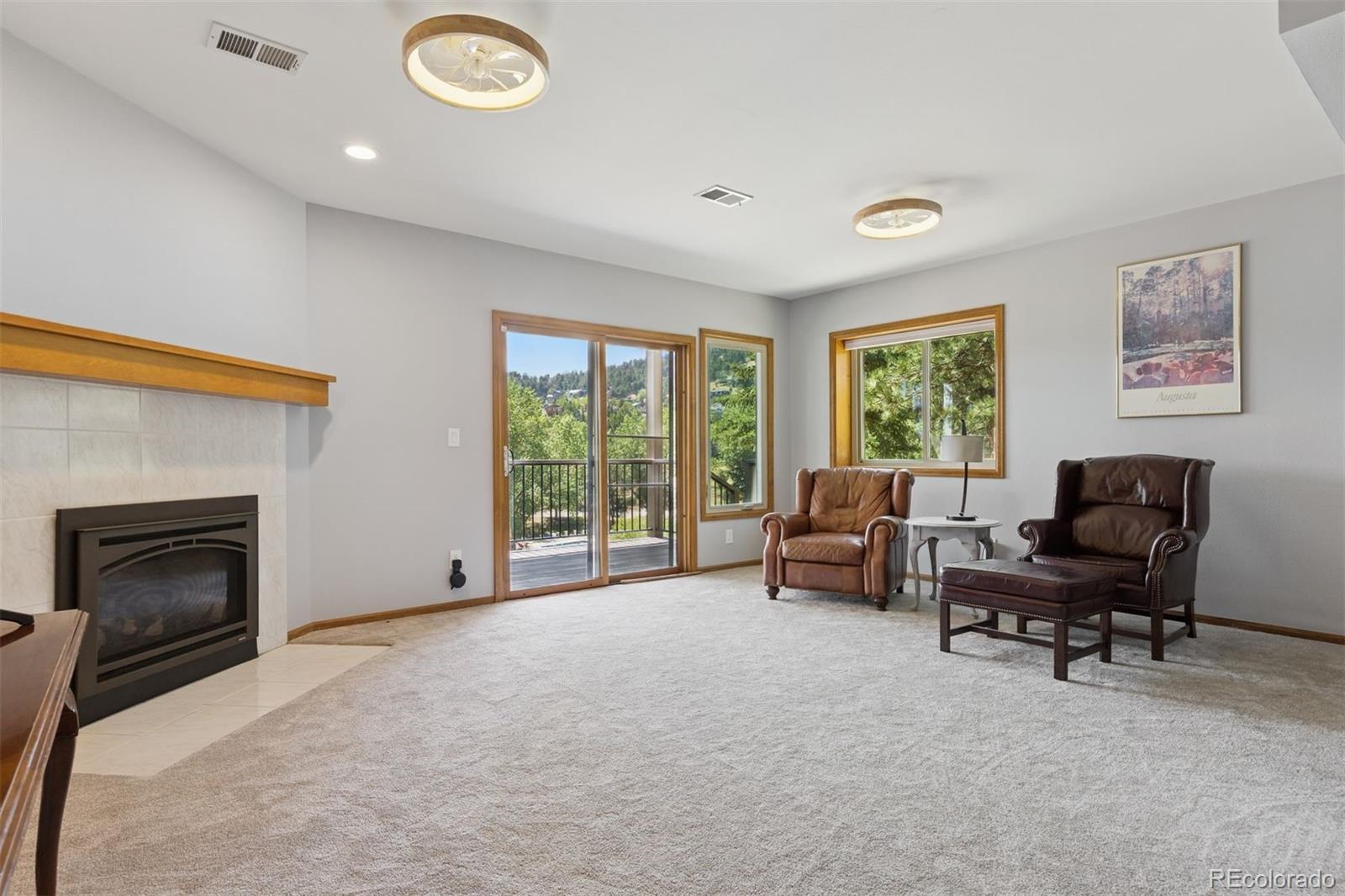 23860 Genesee Village Road Golden, CO 80401 - Photo 25 of 36 a living room with furniture and a fireplace