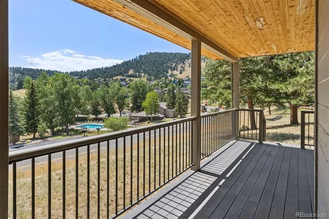 a view of balcony with wooden floor and fence