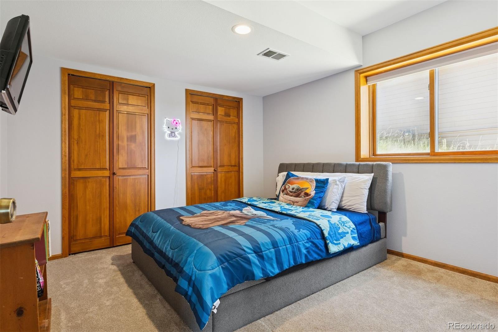 23860 Genesee Village Road Golden, CO 80401 - Photo 28 of 36 a bedroom with a bed and a window