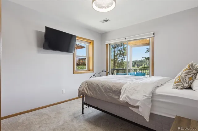 a bed sitting in a bedroom next to a window