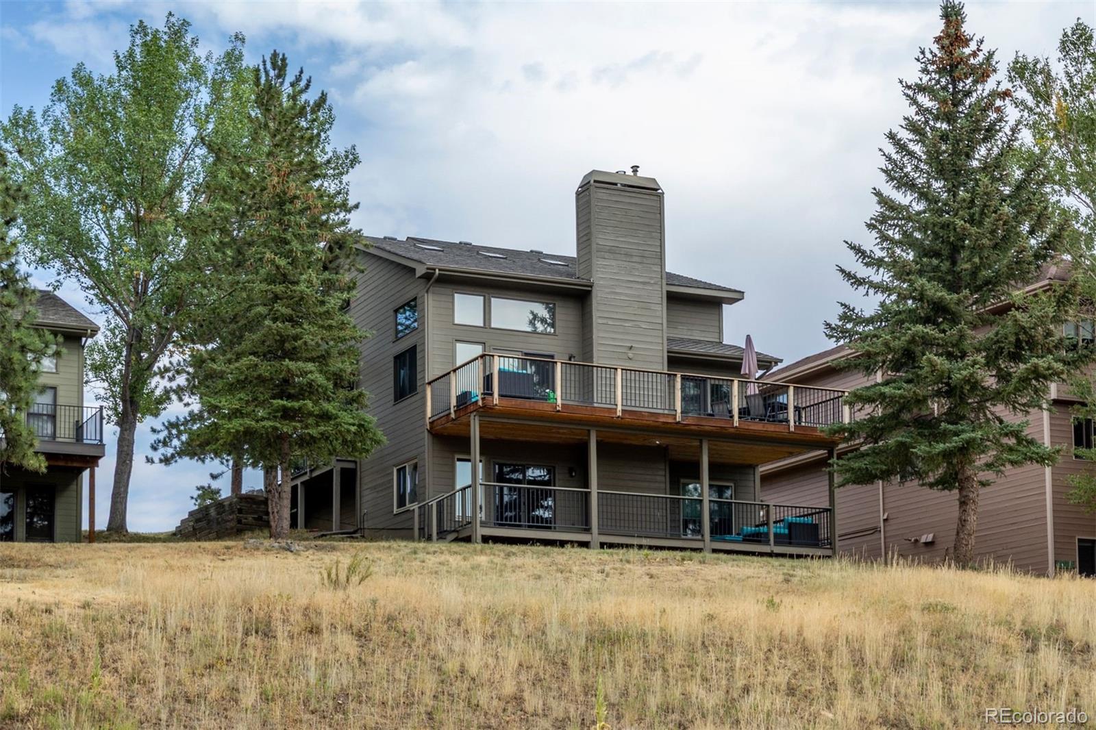 23860 Genesee Village Road Golden, CO 80401 - Photo 31 of 36 a view of a house with a snow in the yard