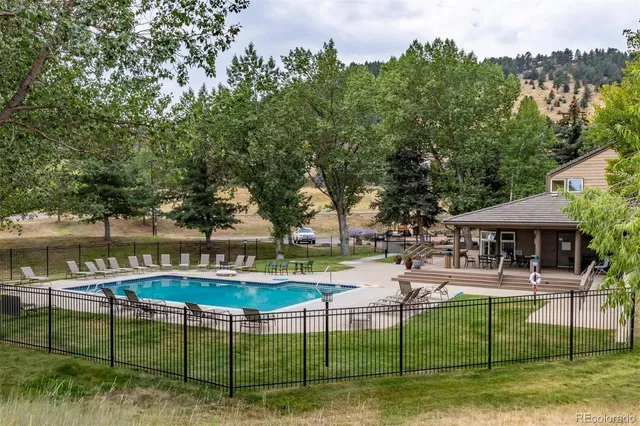 a swimming pool with outdoor seating and yard