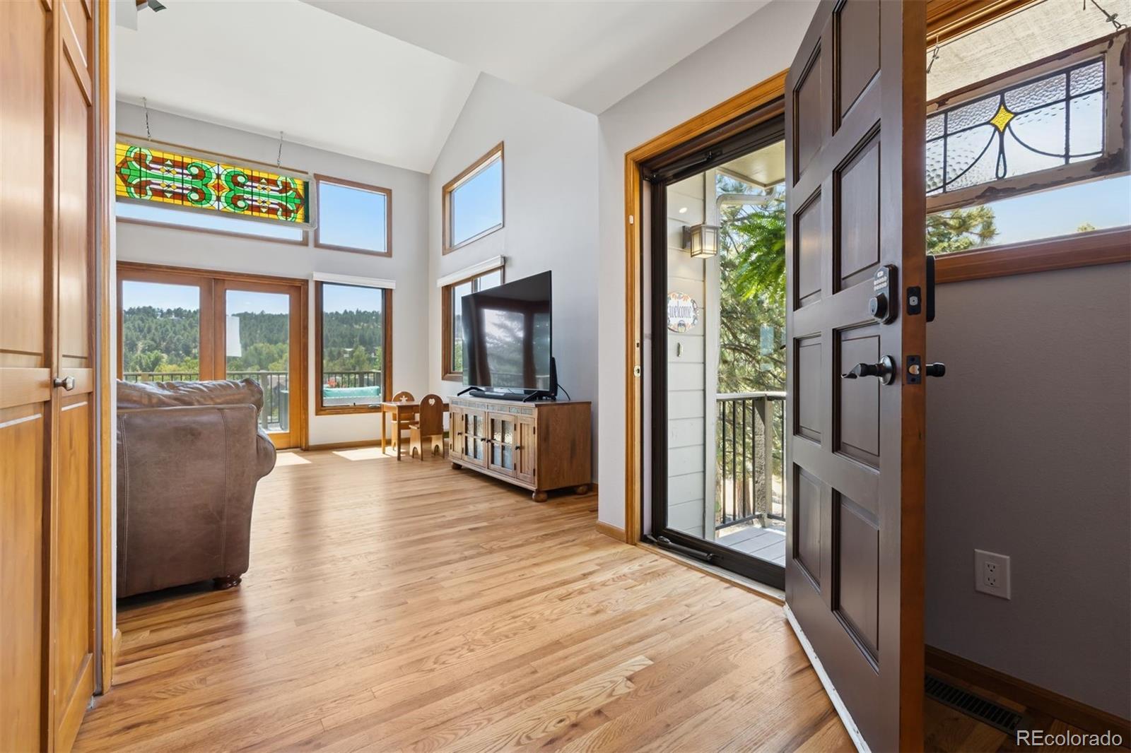 23860 Genesee Village Road Golden, CO 80401 - Photo 6 of 36 a view of a living room with furniture and a flat screen tv