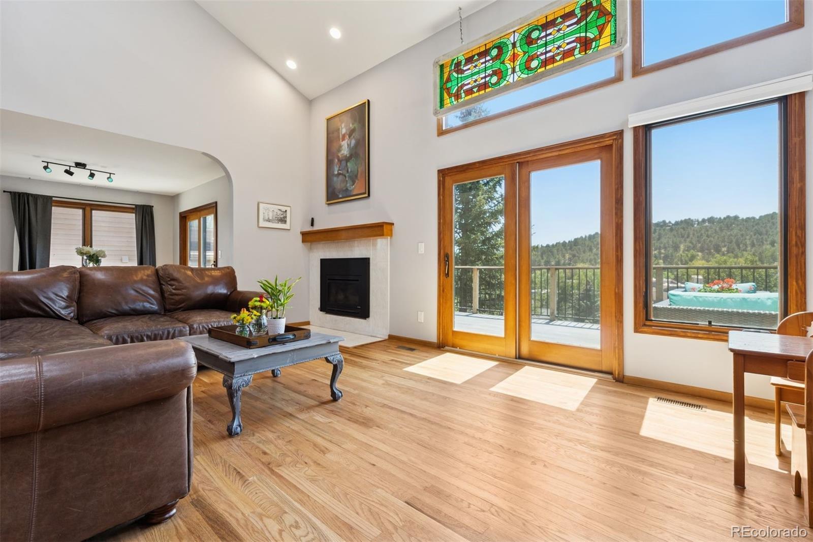 23860 Genesee Village Road Golden, CO 80401 - Photo 7 of 36 a living room with furniture and a fireplace