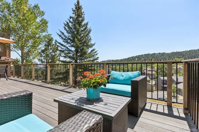 a view of a chairs and table on the wooden deck
