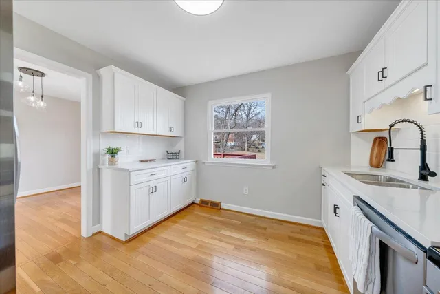 a kitchen with a sink stove and cabinets