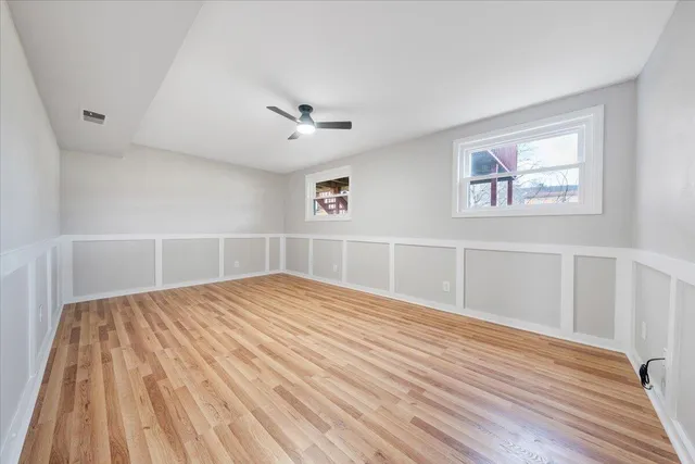 a view of empty room with wooden floor