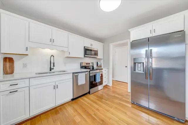 a kitchen with cabinets and stainless steel appliances
