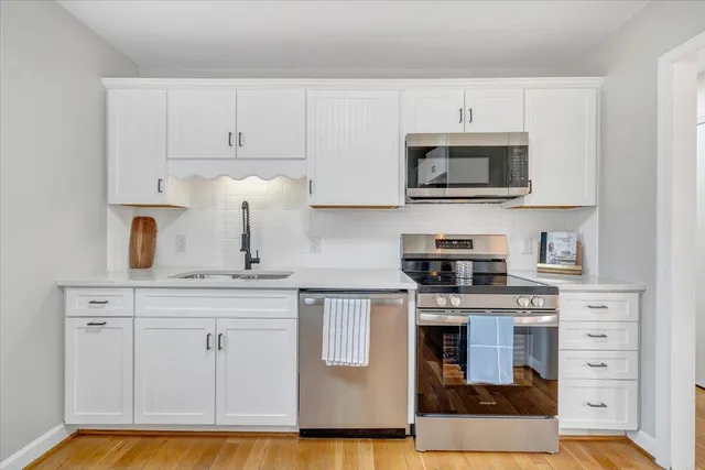 a kitchen with stainless steel appliances granite countertop a stove and a microwave