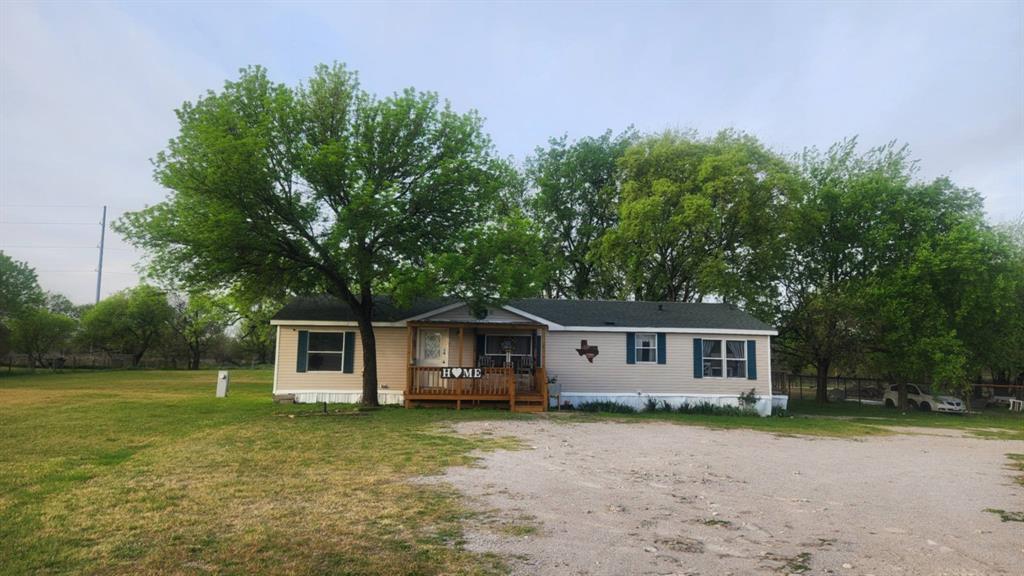 7241 South Interstate 45 Service Road Alma, TX 75119 - Photo 4 of 11 Manufactured / mobile home with a wooden deck and a front yard