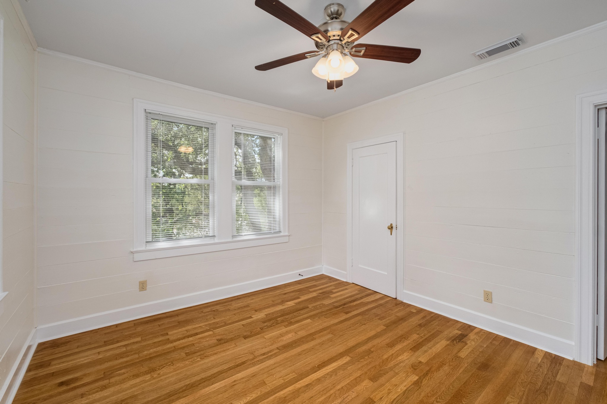 2012 Enfield Road, Unit B Austin, TX 78703 - Photo 14 of 20 Rich hardwood flooring creates a warm foundation for this bedroom, bathed in natural light.