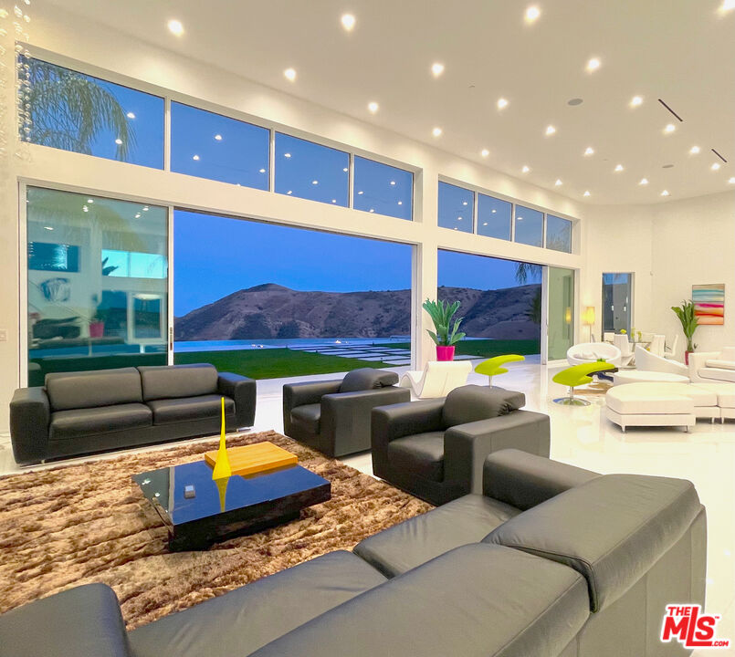 80 Saddlebow Road Bell Canyon, CA 91307 - Photo 11 of 37 a living room with furniture a rug and a floor to ceiling window