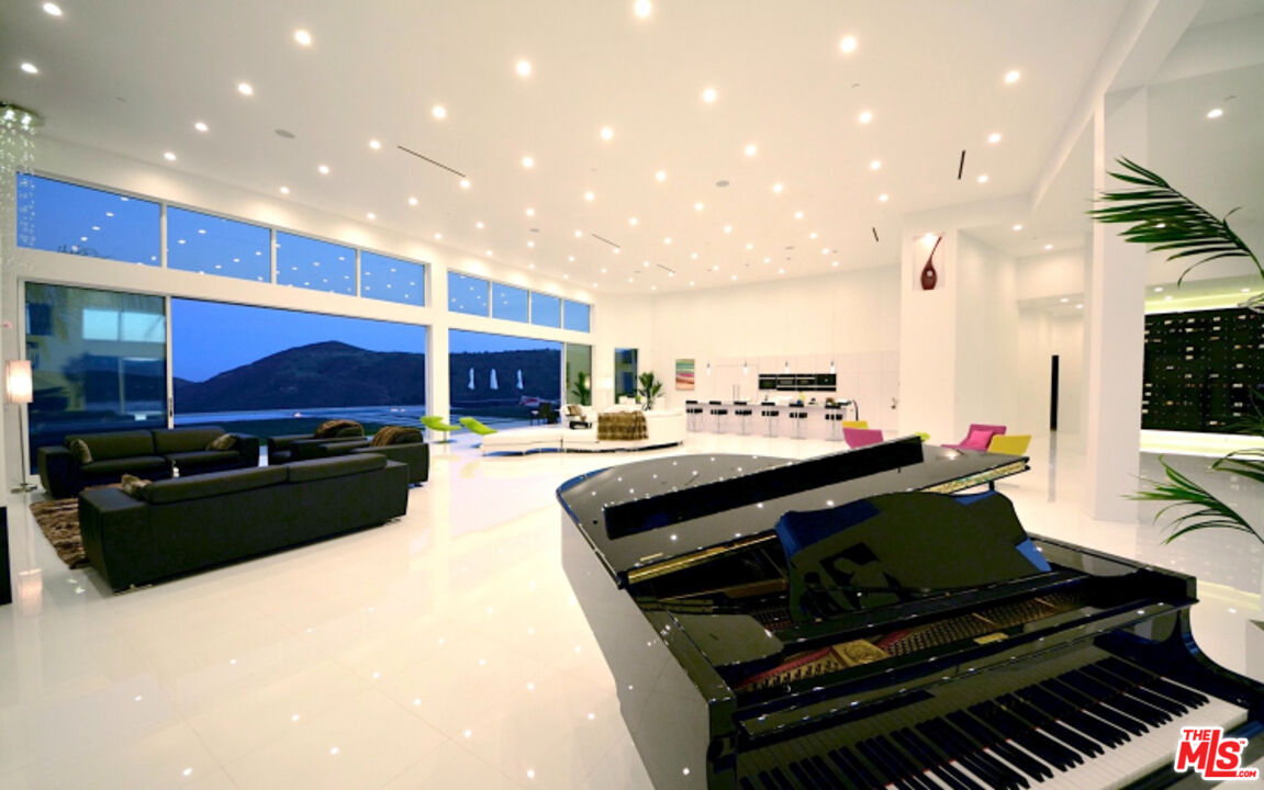 80 Saddlebow Road Bell Canyon, CA 91307 - Photo 13 of 37 a living room with stainless steel appliances kitchen island granite countertop furniture a rug and a kitchen view