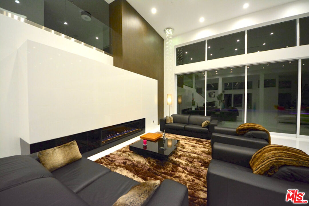 80 Saddlebow Road Bell Canyon, CA 91307 - Photo 23 of 37 a living room with furniture and large windows