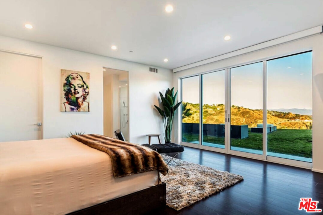 80 Saddlebow Road Bell Canyon, CA 91307 - Photo 32 of 37 a bedroom with a large bed and a large window