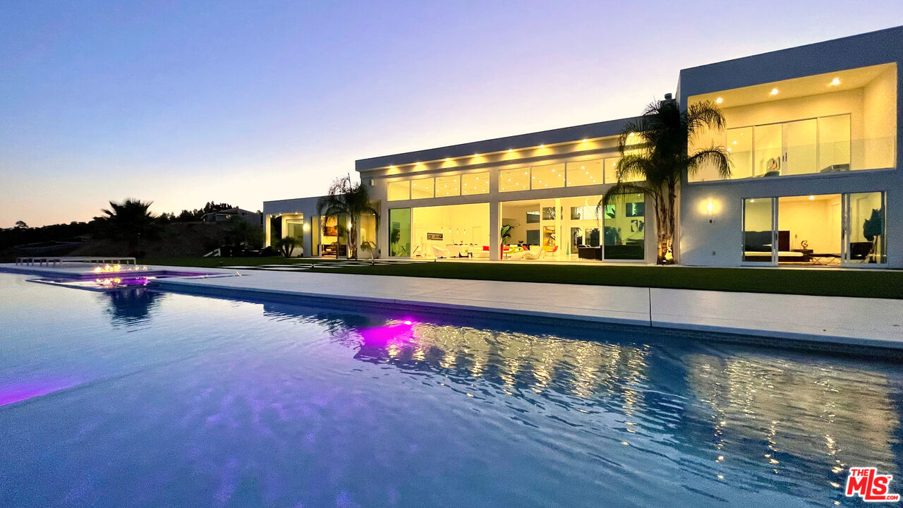 80 Saddlebow Road Bell Canyon, CA 91307 - Photo 33 of 37 a view of swimming pool with a chair and floor to ceiling window