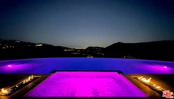 a room with pool table and chairs