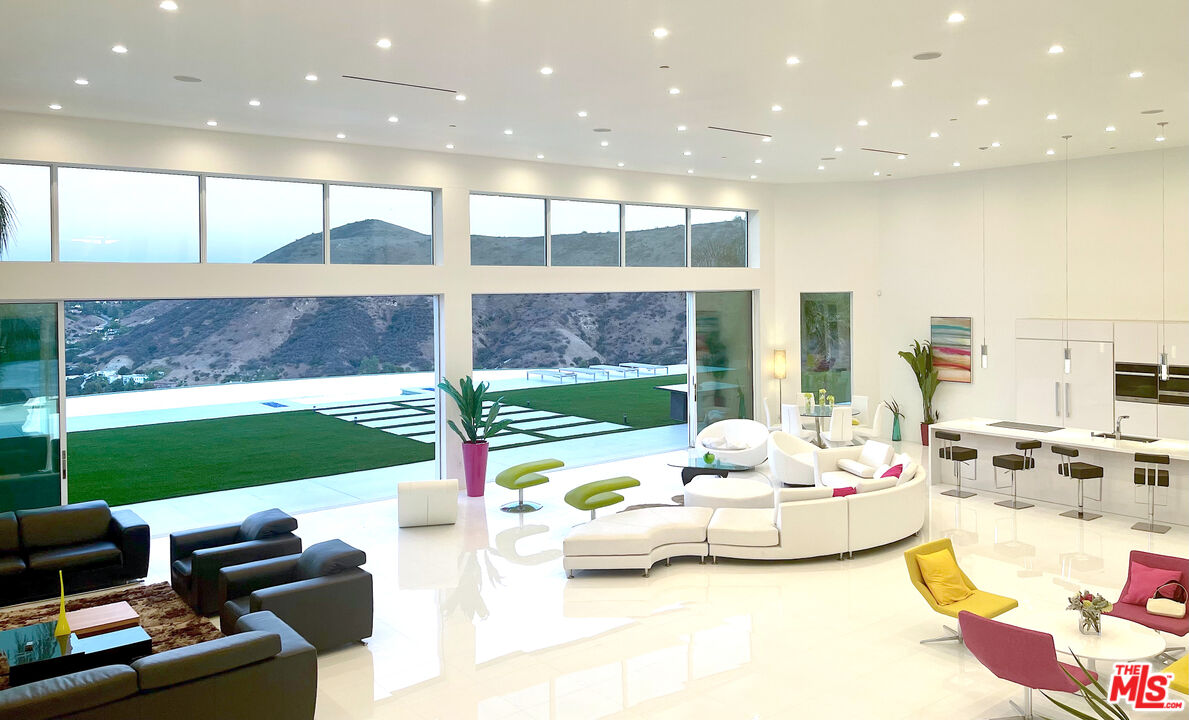 80 Saddlebow Road Bell Canyon, CA 91307 - Photo 9 of 37 a living room with patio furniture and a floor to ceiling window