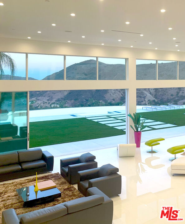 80 Saddlebow Road Bell Canyon, CA 91307 - Photo 10 of 37 a living room with patio furniture and a table